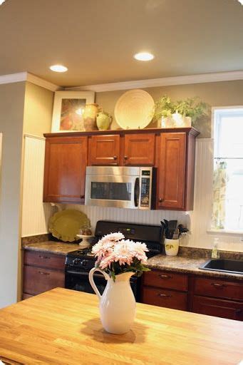 Dimension is the most important factor to utilize when styling. How to Decorate Above Kitchen Cabinets | Decorating above ...
