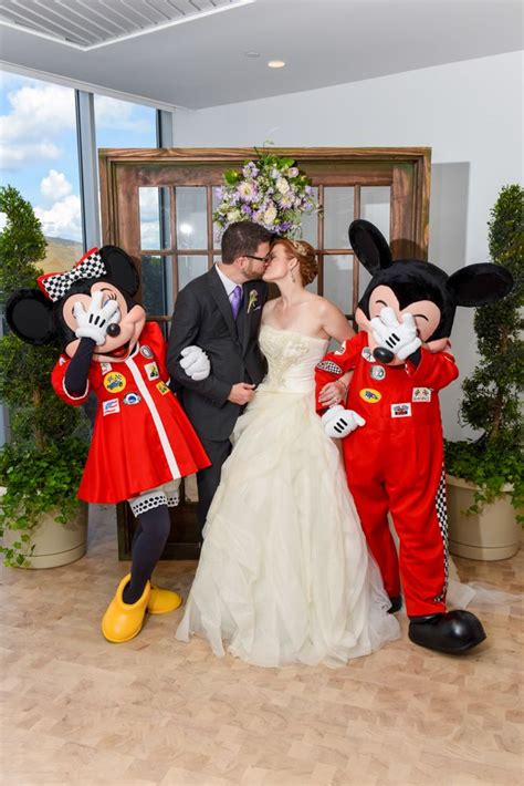 A Cute Moment With Mickey And Minnie Mouse Decked Out In Their Racing
