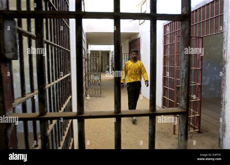 Dpa A Man Walks Along A Corridor Past Rows Of Prison Cells In The