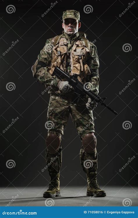 Soldier Man Hold Machine Gun On A Dark Background Stock Photo Image