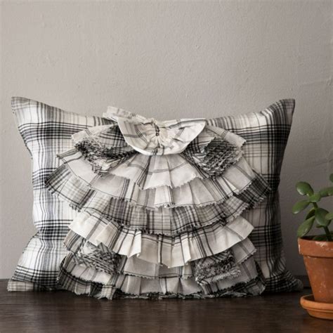 The tailored cushions of this west elm chair contrast sharply with the metal frame, giving it a look that reads both industrial and glamorous. West Elm Plaid Ruffle Pillow Knockoff