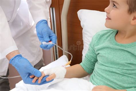 Doctor Adjusting Intravenous Drip For Little Child Stock Image Image