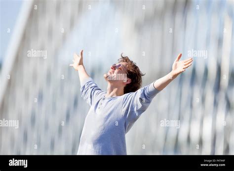Excited Young Man Stretching Out His Arm In Emotion Outdoors Stock