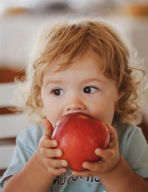 Premium Photo Funny Baby Eat Apple Kid Eating Fruit Little Boy Biting
