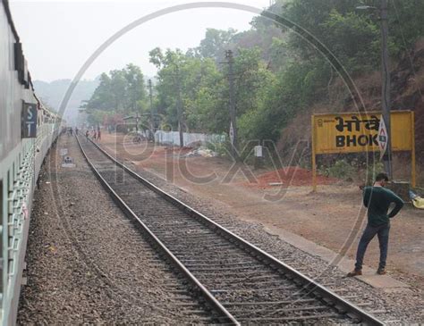 image of indian mail train on railway track the vast indian rail network carries 25 million