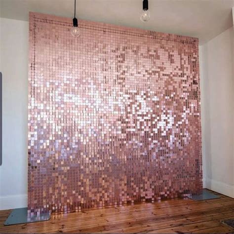 A Room With Wooden Floors And A Wall Made Out Of Pink Mosaic Tiles On