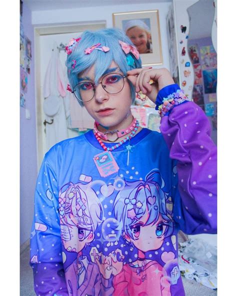 A Woman With Blue Hair Wearing Glasses And A Shirt That Has Cartoon