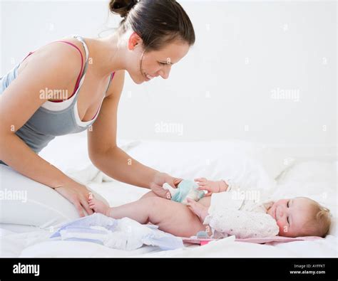 Mother Changing Babys Diaper Stock Photo Alamy