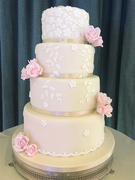 Ivory Cake With White Handcut Leaves And Blossoms And Pale Pink Sugar
