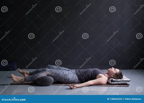 Woman Working Out Doing Yoga Exercise On Wooden Floor Lying In