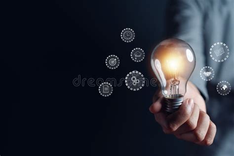 Man Hand Holding Lightbulb With Learning Educate And Graduation Concept