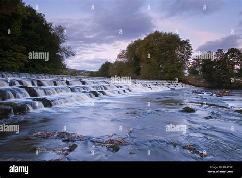 Scenic Evening Rural Landscape Of Water Flowing And Tumbling Over