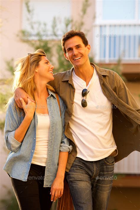 Happy Couple Walking Together On Date Laughing Stock Photo By