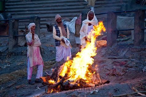 Body Burns On Funeral Pyre At Hindu Cremation By River Ganges Tim
