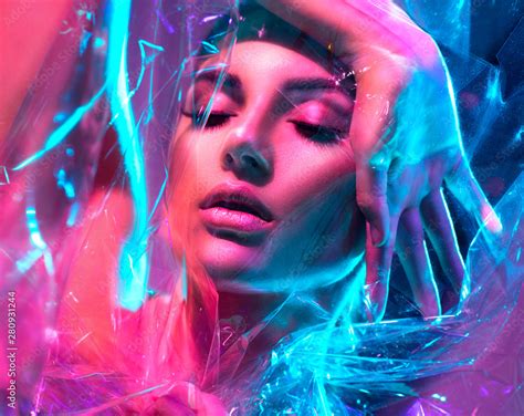 Fashion Model Woman In Colorful Bright Neon Lights Posing In Studio