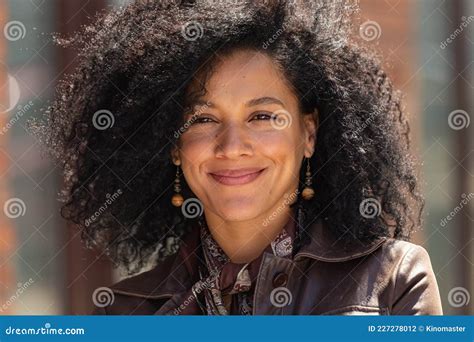 Portrait Of Stylish Young African American Woman Smiling Happily Brunette With Curly Hair In