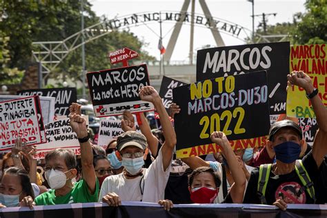 Philippines Activists Carry Marcos Is No Hero Banner To Mark Burial