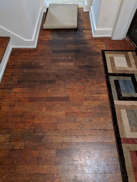 Parents old house they bought has brown/black spots on the hardwood floor. How do i clean/fix ...