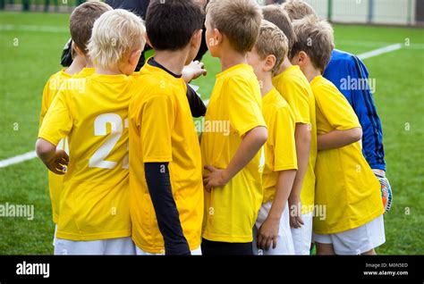 Young Football Soccer Players With Coach Coach Motivate Children Kids