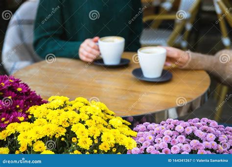 Two Girls Drink Cappuccino in a Coffee Shop Close Up Hands. Stock Image