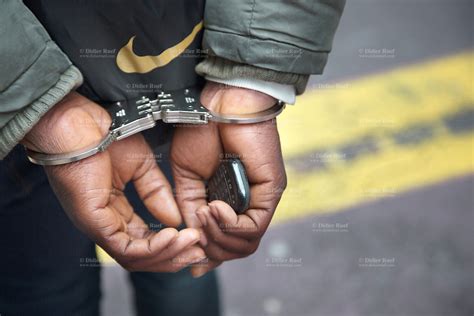 Narcotics Squad Policemen Arrest Inmate African Man Handcuffed Mobile Phone Didier Ruef