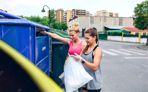 Premium Photo Girls Throwing Garbage To Recycling Dumpster