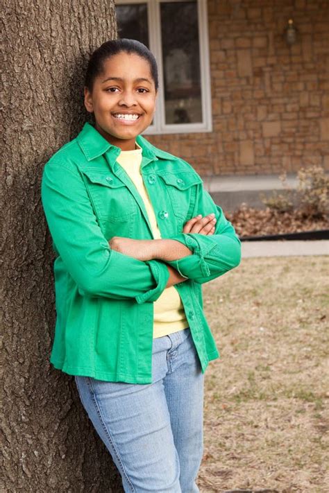 Young African American Teenage Girl Standing Outside And Smiling Stock
