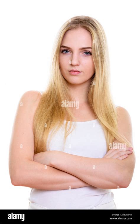 Studio Shot Of Young Beautiful Teenage Girl With Arms Crossed Stock
