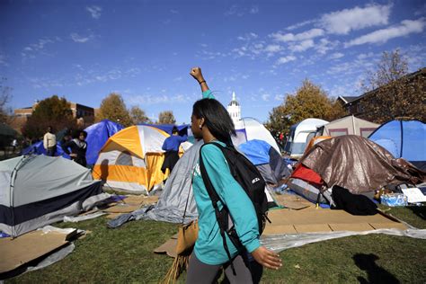 A Woman Passes A Tent Encampment Set Up By Student Protesters At The