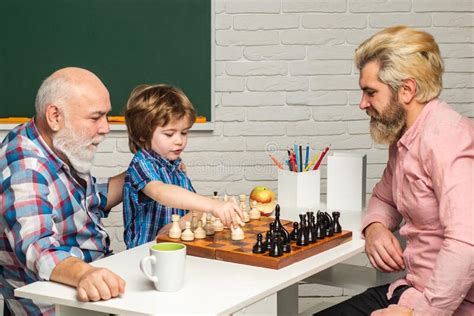 Grandfather Father And Son Playing Chess Grandpa Teaching Grangson At