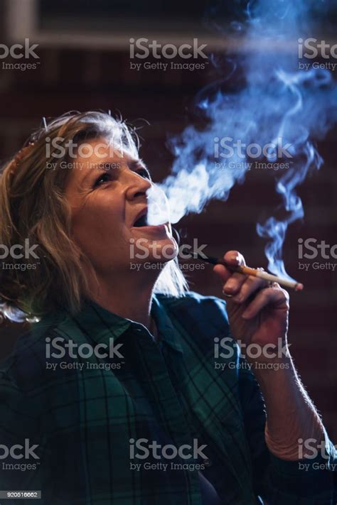 Senior Woman Smoking A Cigarette Stock Photo Download Image Now 60