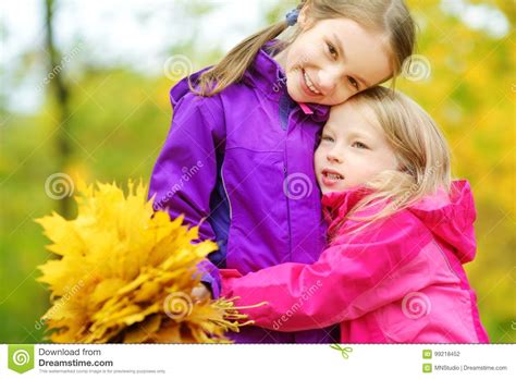 Two Cute Little Girls Having Fun On Beautiful Autumn Day Happy