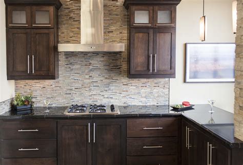 Should not be used in applications submerged in water. Dark stained cabinetry with glass and stone mosaic ...