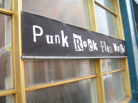 A Sign On The Side Of A Building That Says Punk Rock Flea Market In White