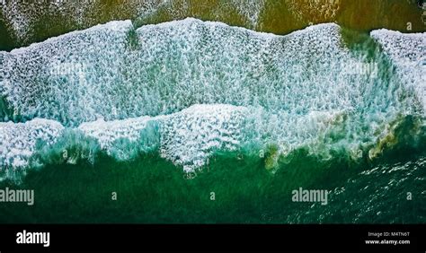 Aerial View From Flying Drone Of Ocean Waves Crushing On Beach Stock