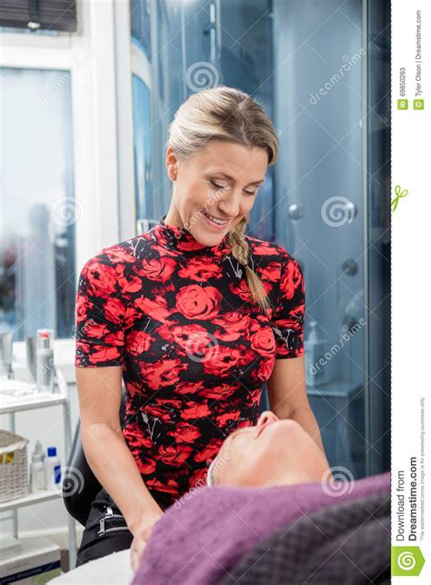 Beautician Smiling While Looking At Client In Salon Stock Image Image
