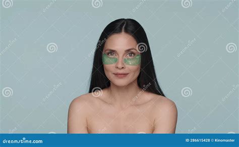 Brunette Woman Doing Facial Skin Care Procedures Portrait Of A Seminude Woman With Green