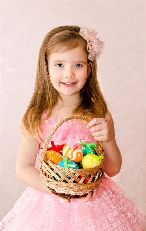 Little Girl With Basket Full Of Colorful Easter Eggs Stock Photo