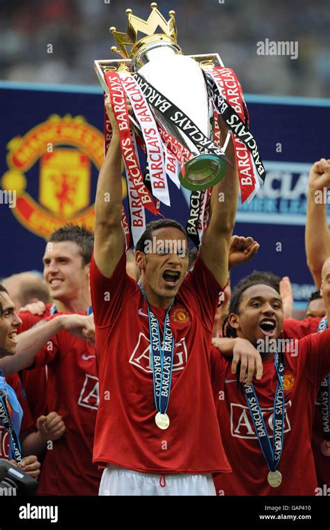 Manchester Uniteds Rio Ferdinand Celebrates With The Trophy Following