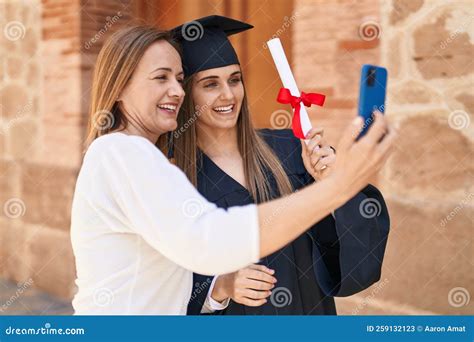 two women mother and graduated daughter having video call at campus university stock image