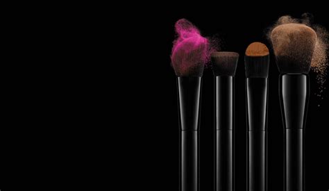 Brushes With Coloured Make Up On A Dark Background Brushes And Make Up