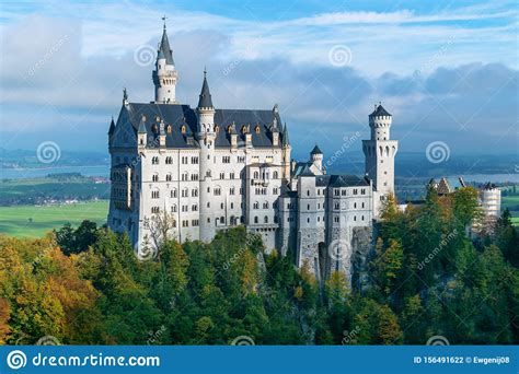 Neuschwanstein Castle In The Morning Sun In Autumn With A Cloudy Sky In