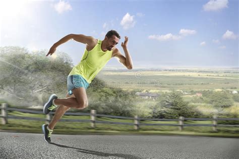 Male Runner Sprinting During Outdoors Training For Marathon Run Stock