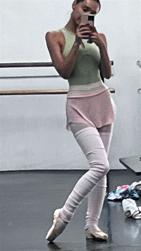 A Woman Is Taking A Selfie With Her Cell Phone In A Ballet Class Room