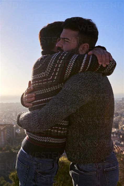 Loving Gay Men Embracing While Standing Against Clear Sky During Sunrise Bunkers Del Carmel