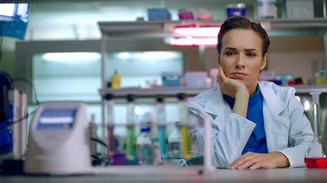 Woman Chemist Sitting At Workplace In Chemical Laboratory Chemist