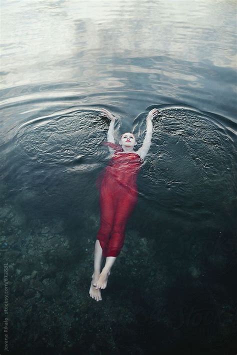 Woman In A Red Dress Floating On Water By Stocksy Contributor Jovana