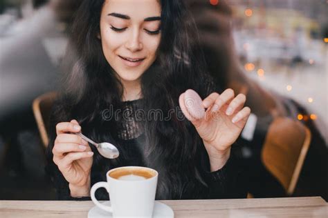 Beautiful Young Woman Enjoying Coffee Cappuccino With Foam Near Window