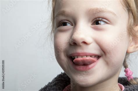 Happy Little Girl Showing Her Tongue Buy This Stock Photo And