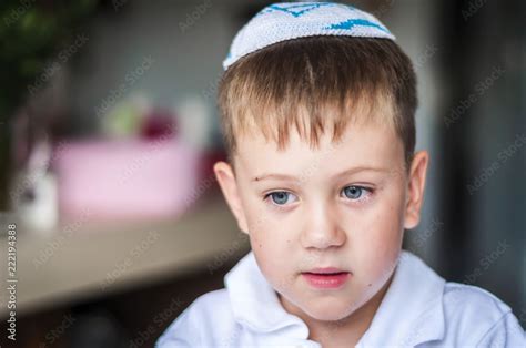 A Beautiful Blue Eyed Caucasian Kid With A Traditional Jewish Kippah